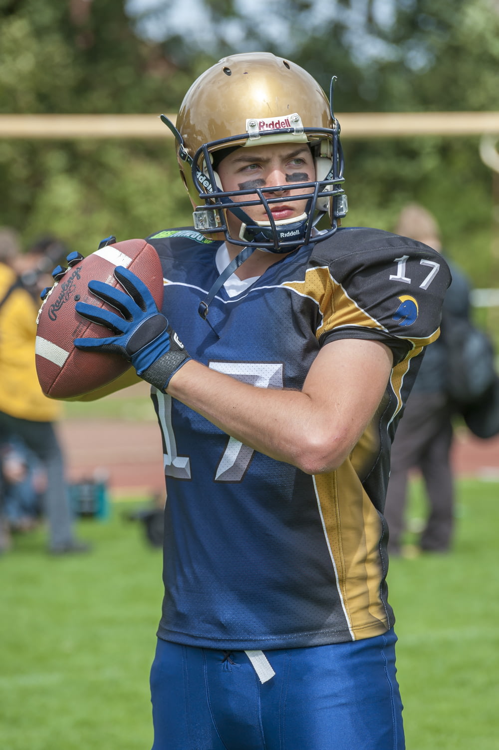 a football player holding a football on a field