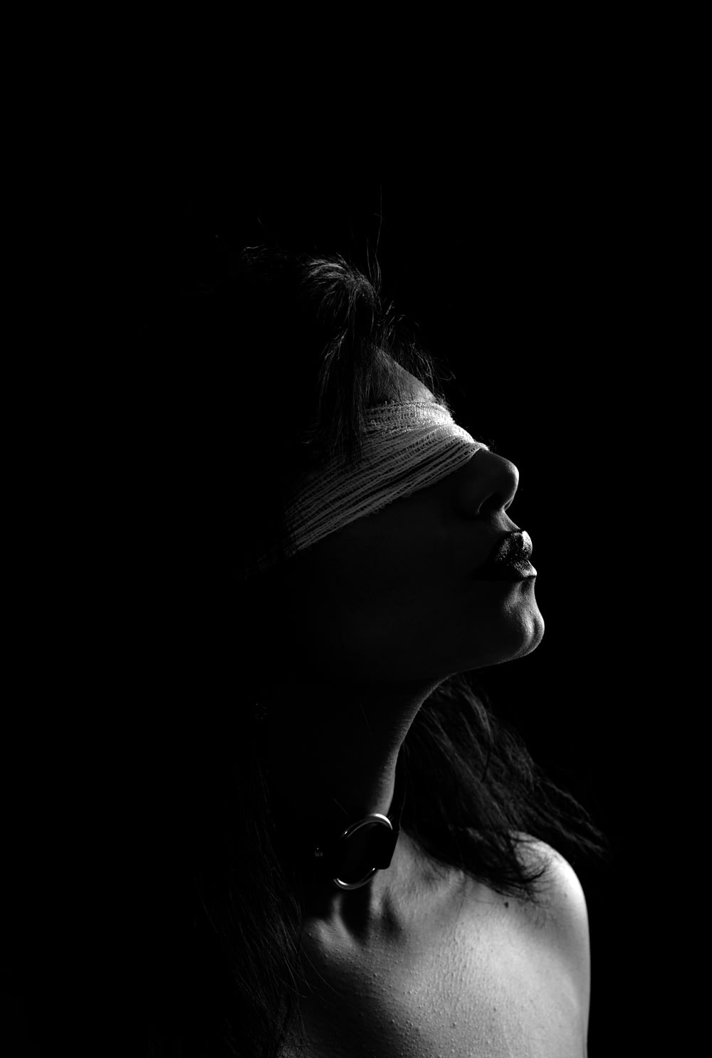grayscale photography of woman wearing blindfold