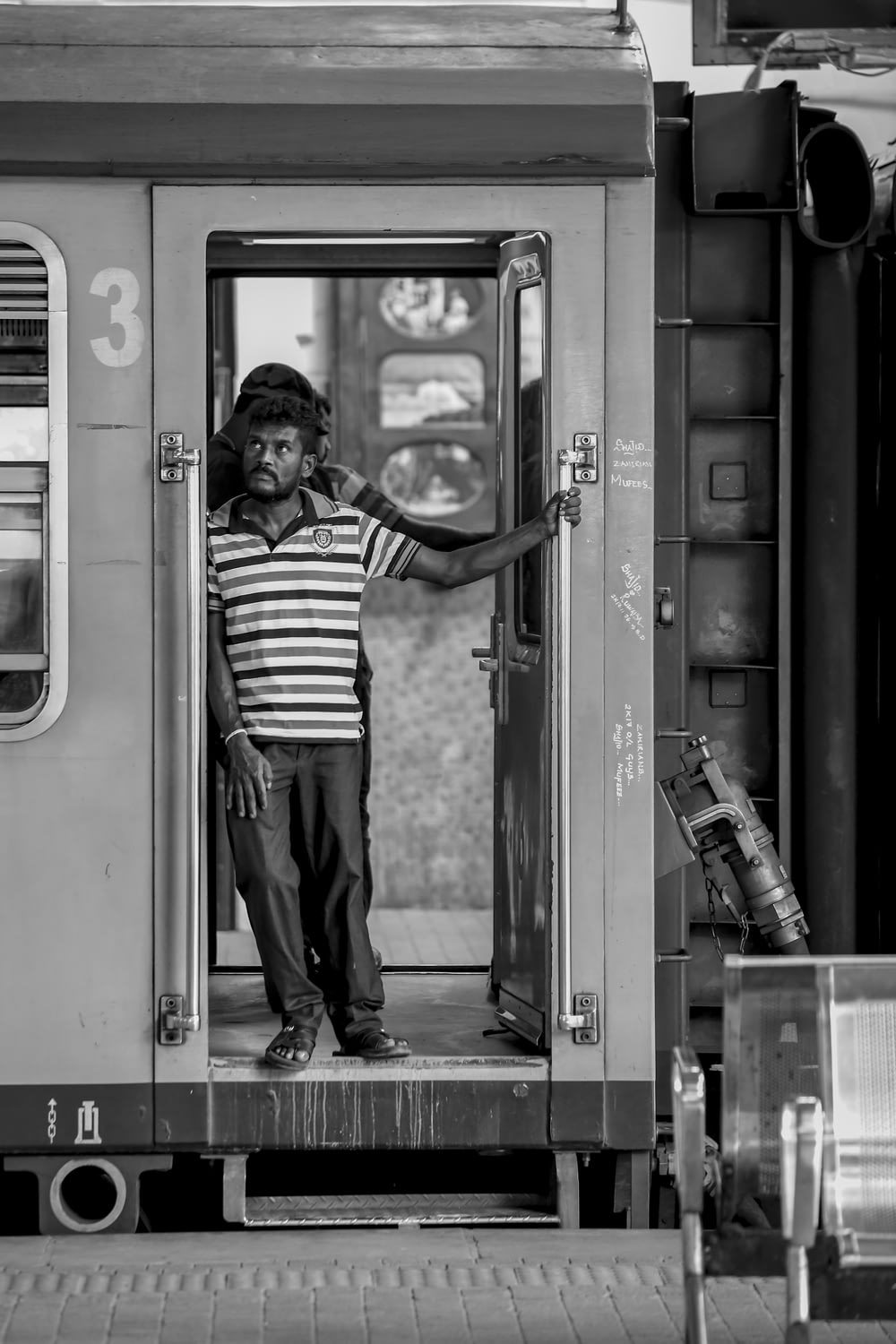 grayscale photography of man in train