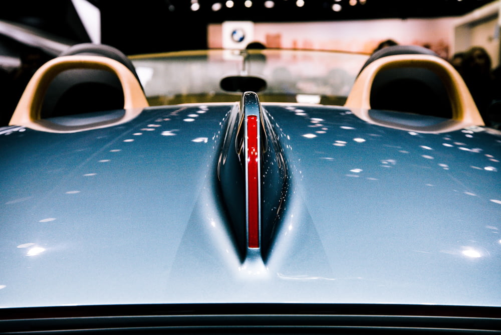 closeup photography of blue vehicle hood