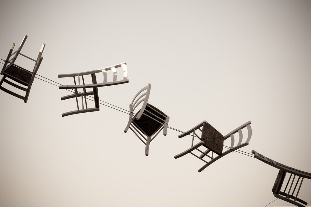 five brown wooden chairs