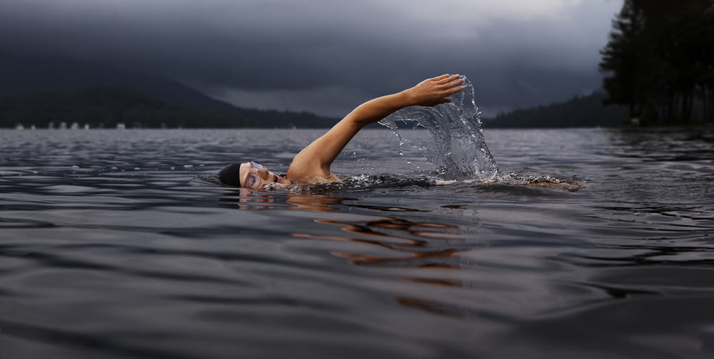 Homme nageant sur un plan d’eau