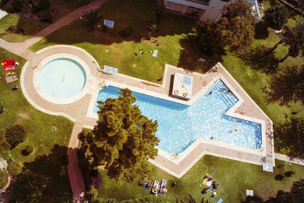 aerial shot of white and blue swimming pool