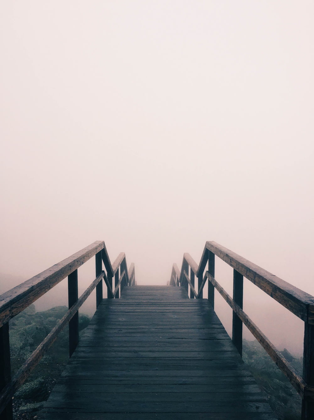 black wooden stairway covered with fog