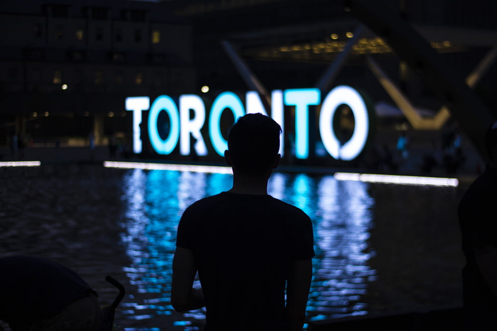 man facing Toronto LED signage