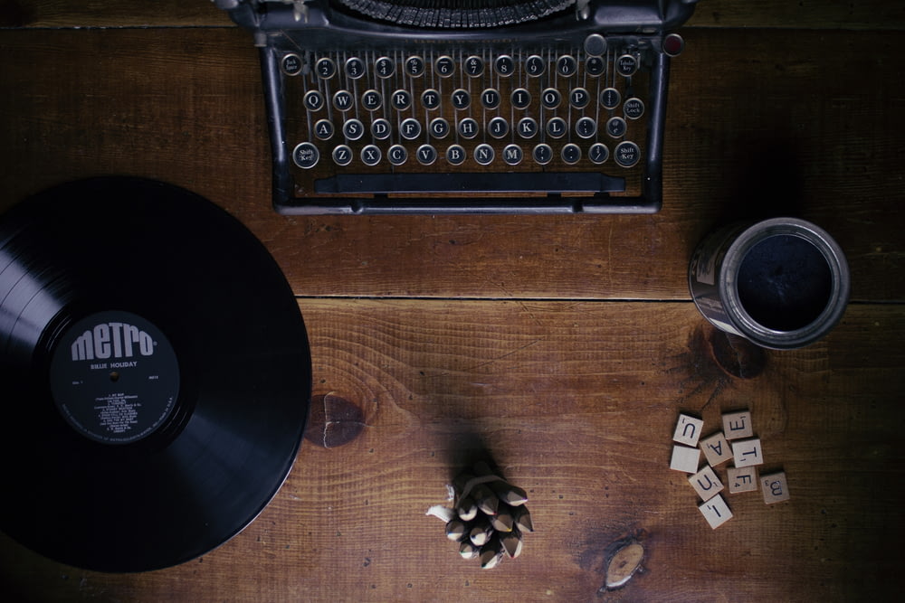 black typewriter beside black Metro vinyl record