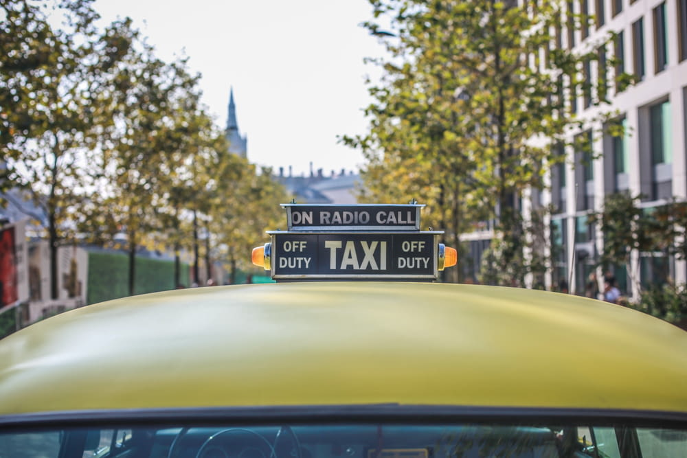 selective focus photography of taxi cab signage