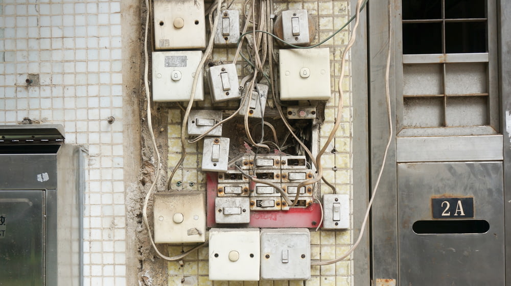 several assorted power switches mounted on white wall