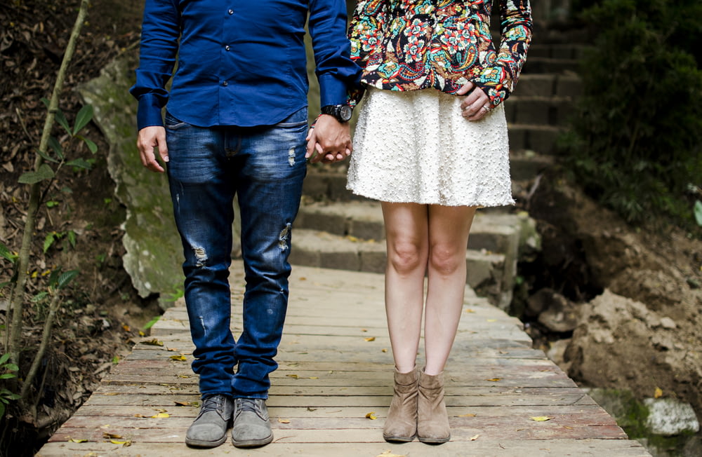 man and woman holding hands during daytime