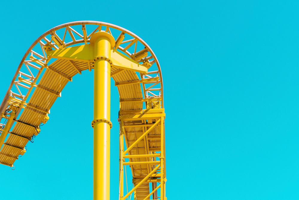 yellow roller coaster rail under clear sky