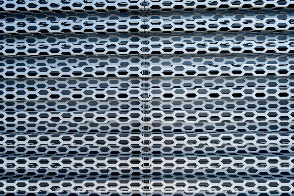 a close up of a metal structure with holes
