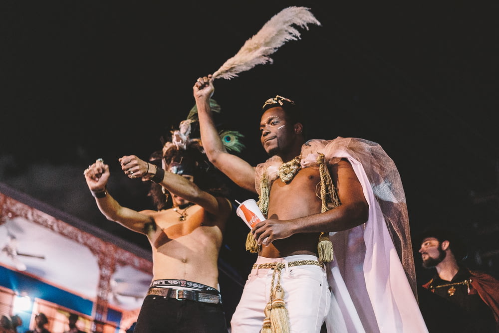 two topless men performing