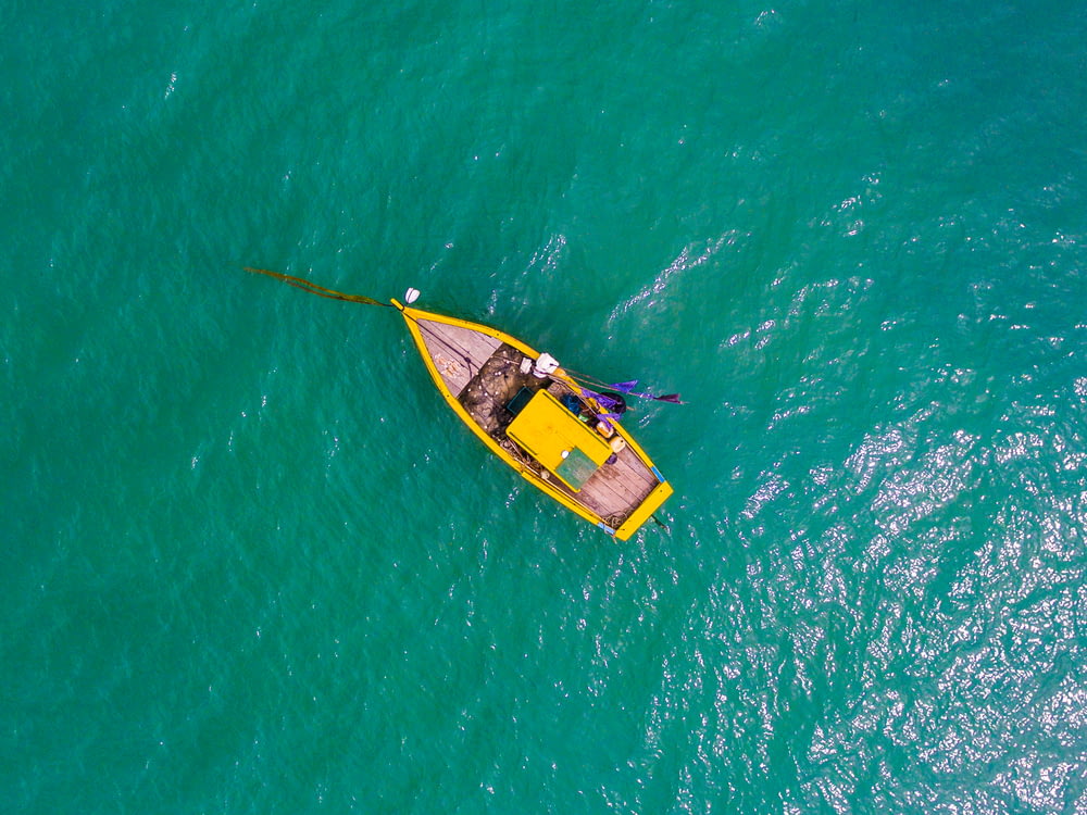 aerial view photography rowboat on body of water