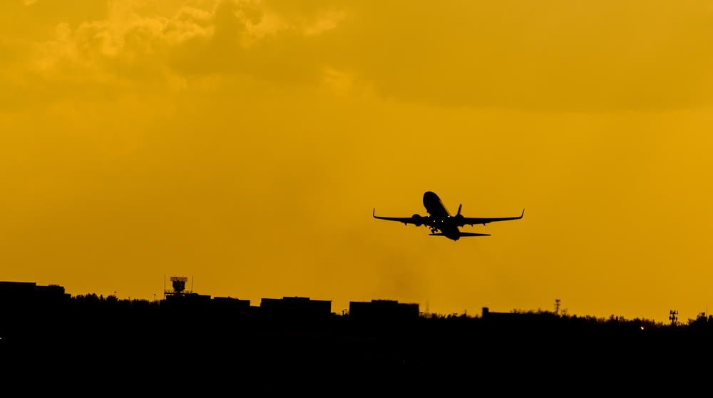 silhouette photo of flying airplane