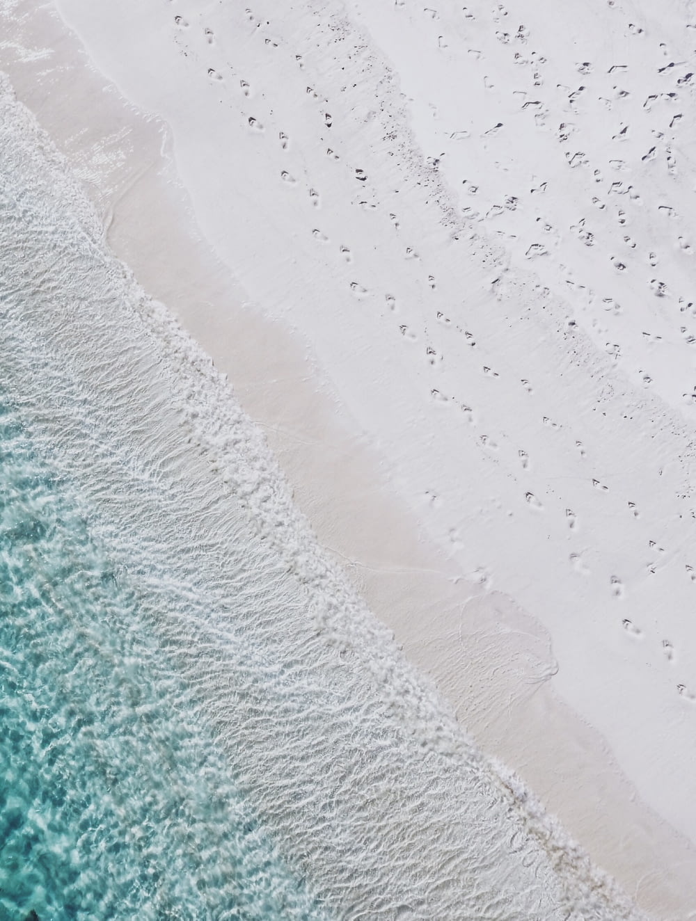 aerial photography of white sand seashore and green water beach