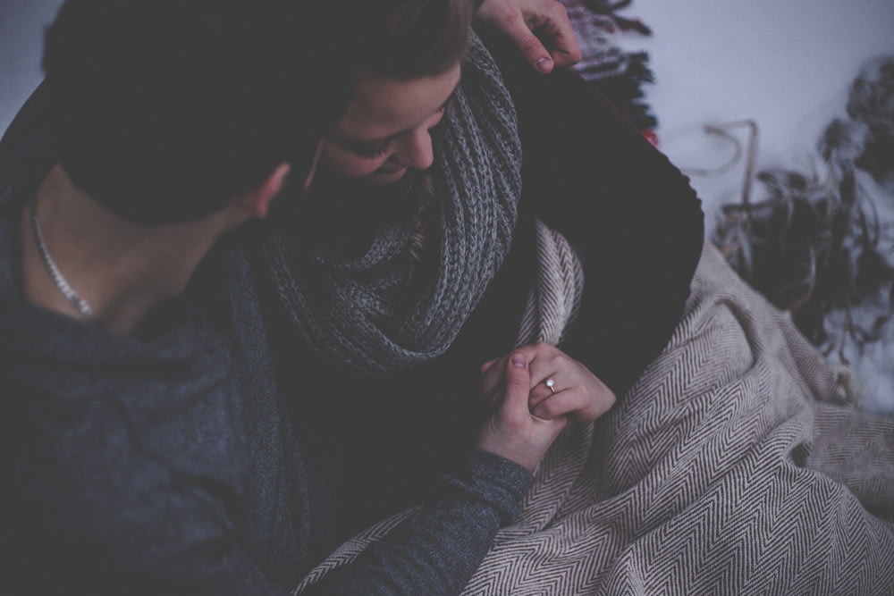 couple with grey blanket
