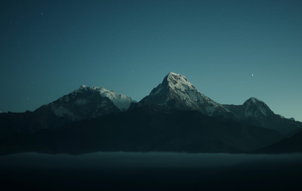 silhouette of mountains during nigh time photography
