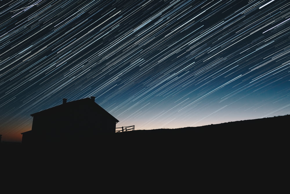 time-lapse photography of house silhouette at night