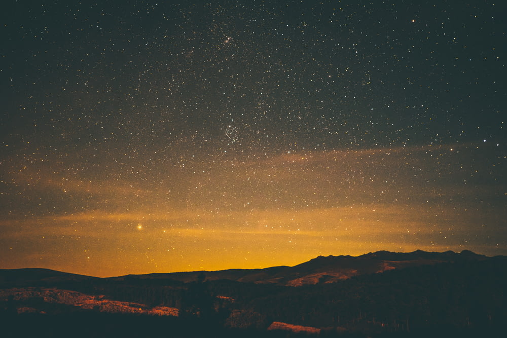 night sky with stars above mountain