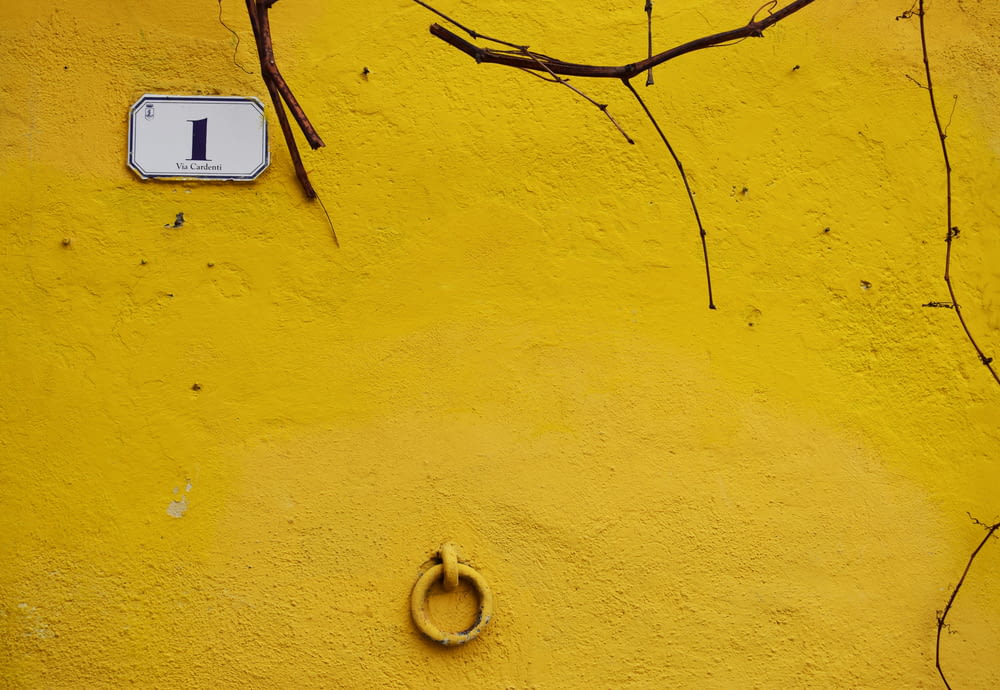 a yellow wall with a number one on it