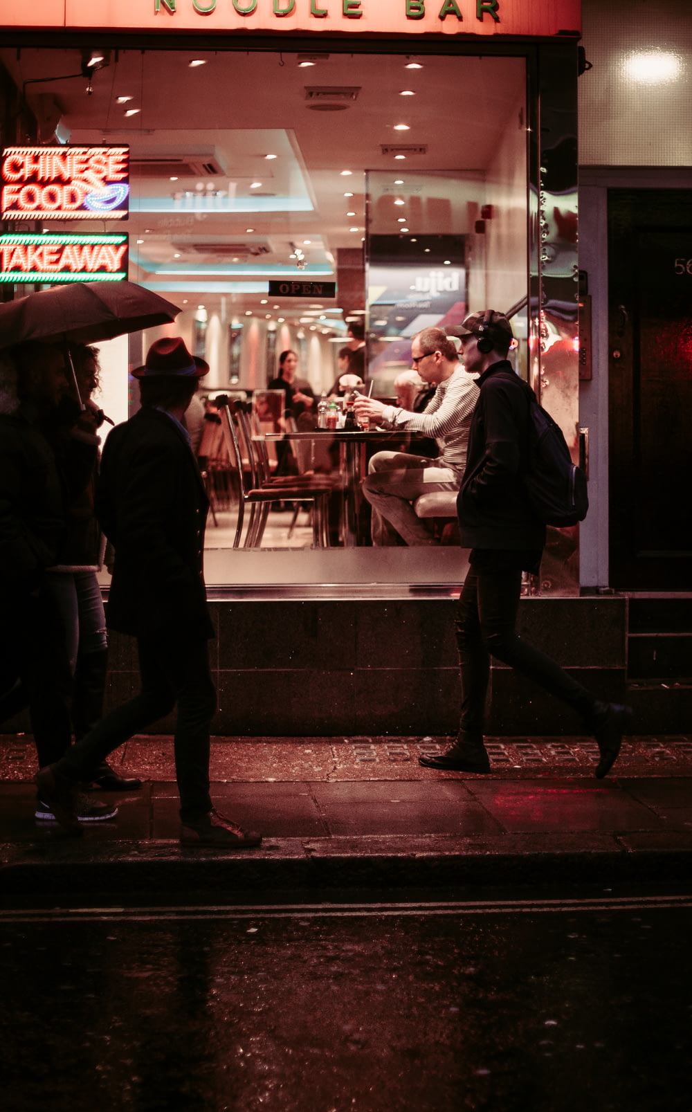 man walking near restaurant wearing jacket