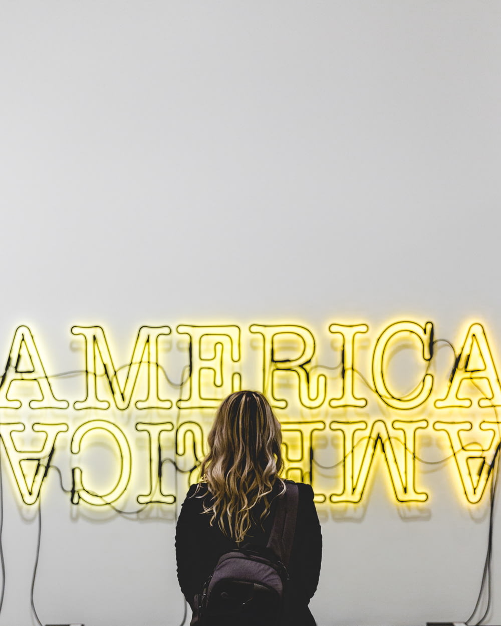 woman in front American lighted signage