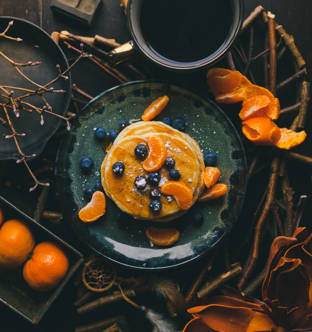 pancakes with orange and blueberry on plate