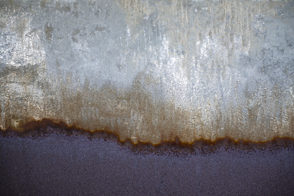 a close up of a wall with brown and white paint