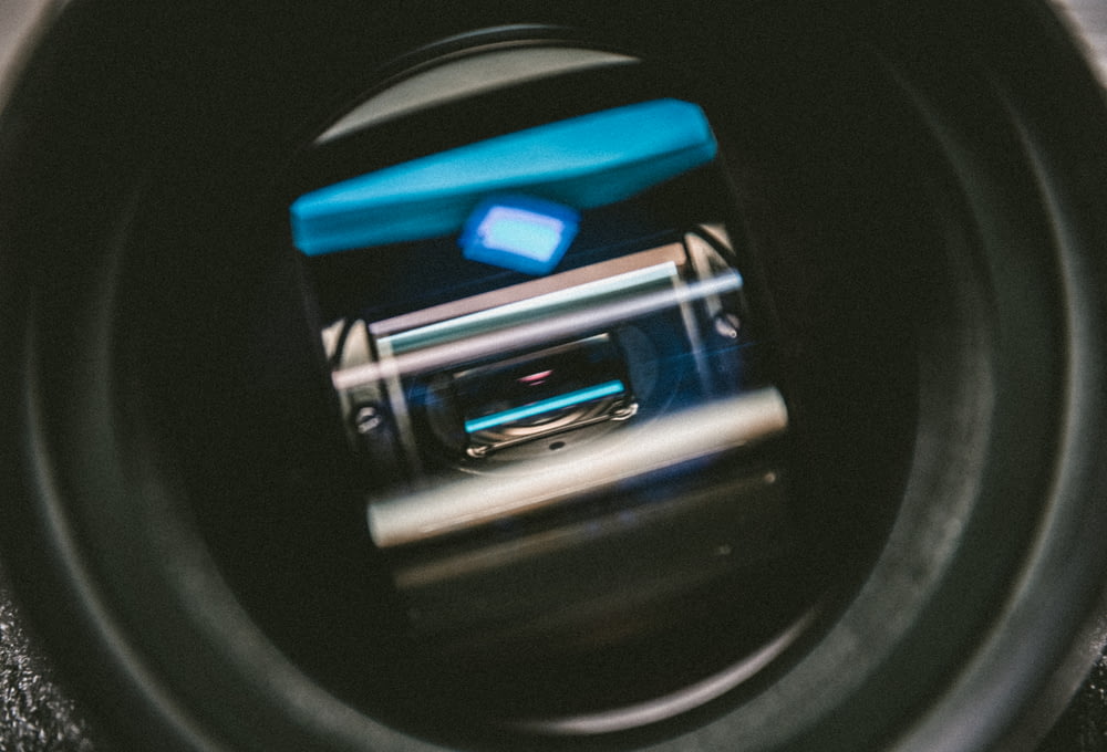 a close up of a camera lens with a cell phone in it