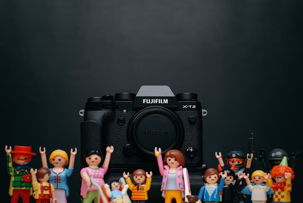 black Fujifilm camera body with minecraft toy lot