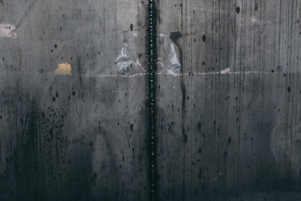 a close up of a metal door with water droplets on it