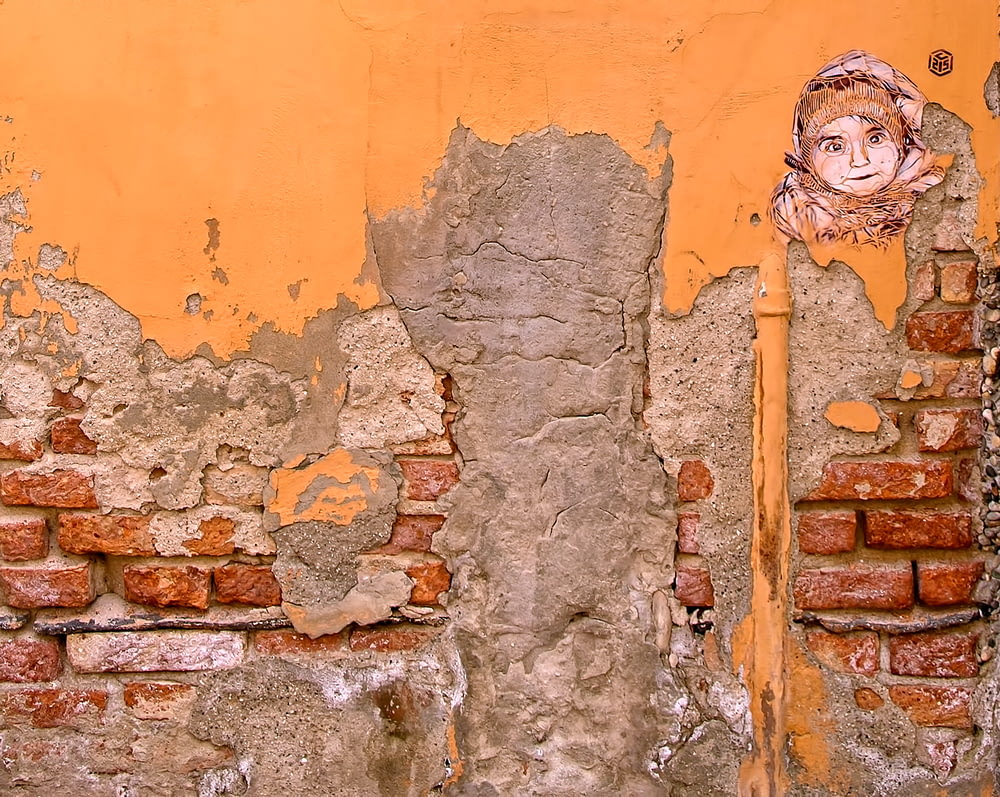 closeup photo of orange and gray wall paint