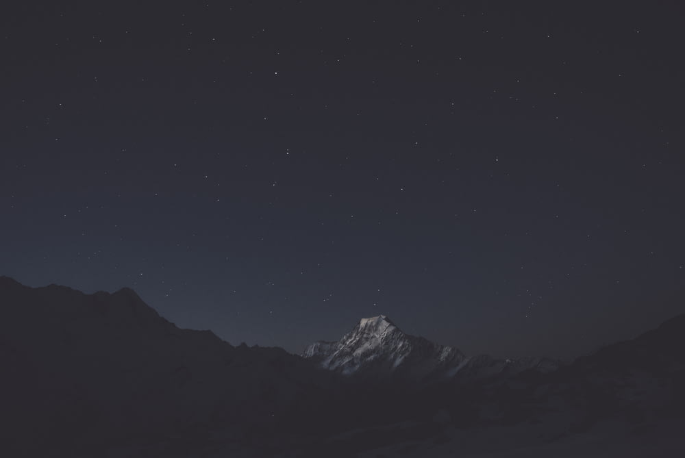 snow covered mountain during nighttime