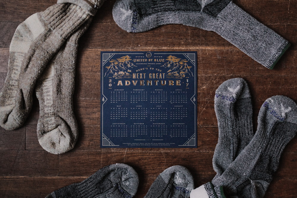 paio di calzini grigi e calendario blu sul tavolo
