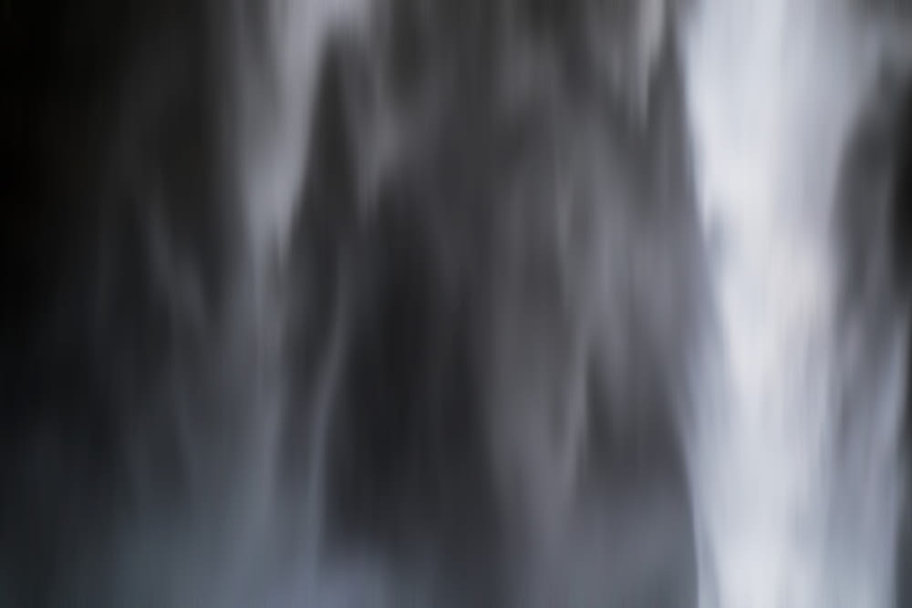 Black and white blurred close up shot of Seljalandsfoss waterfall