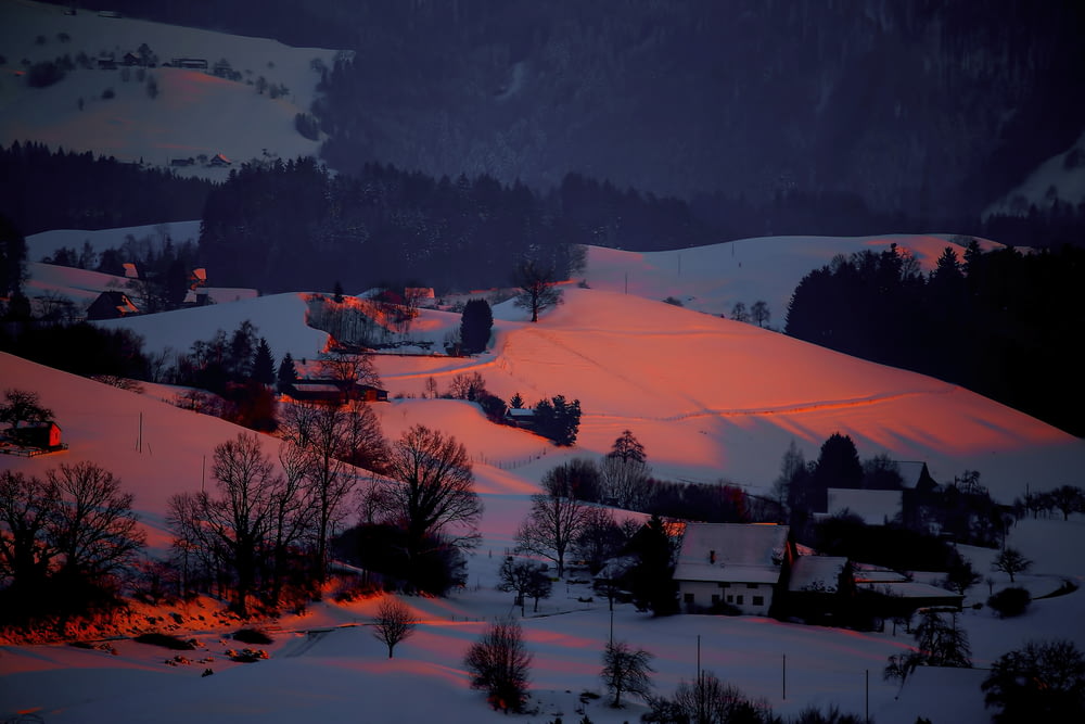 snow covered town during sunset