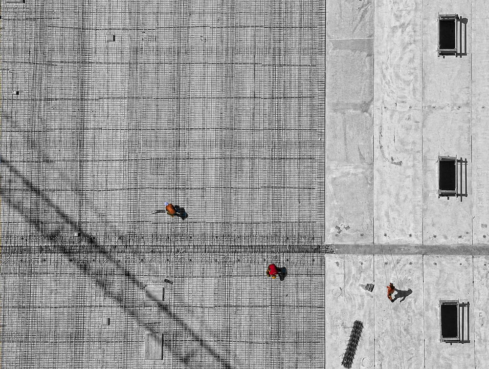 aerial photo of three person walking on floor at daytime