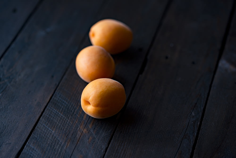 three fruits on wooden surface