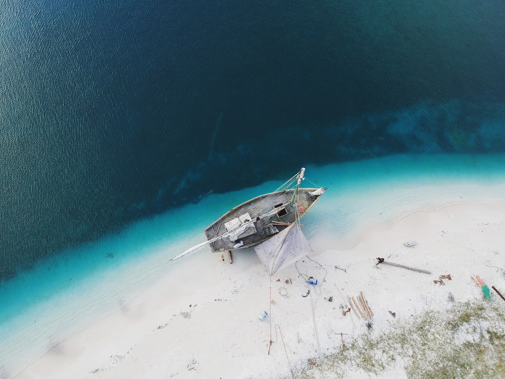 aerial photo of boat on seashore during daytime