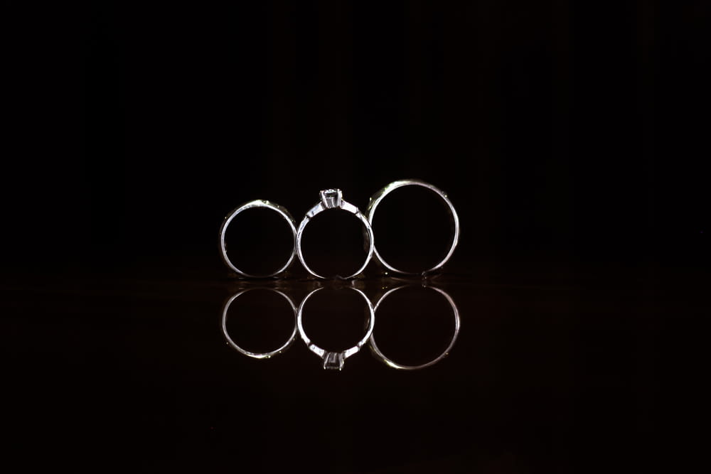 closeup photography of three silver-colored rings