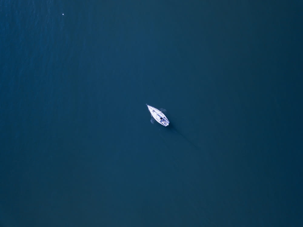 aerial photography of white boat on body of water