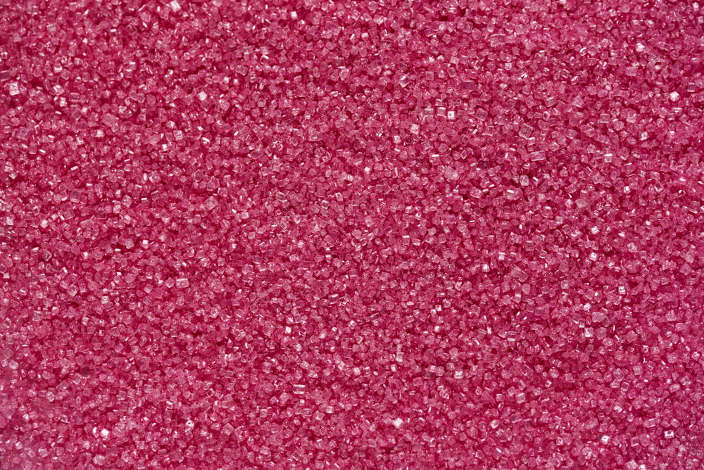 a close up of a pink glitter background