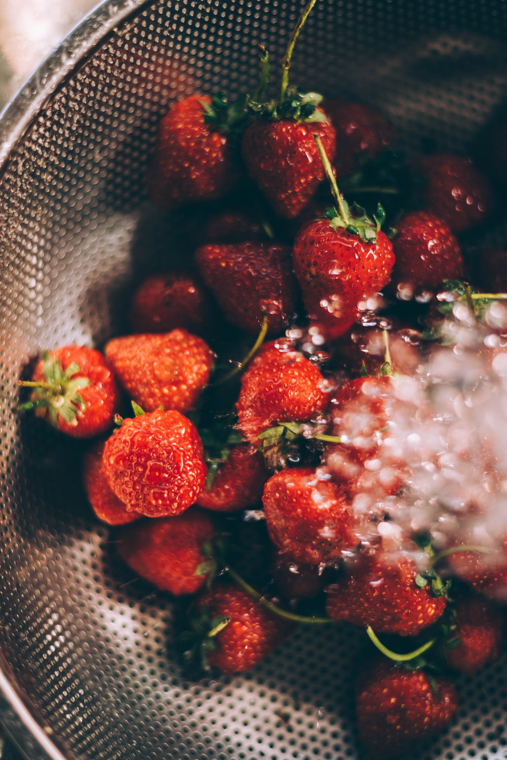 reife Erdbeeren auf grauem Stahlsieb