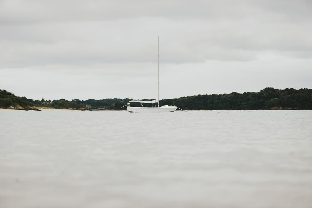 white boat near island during daytime