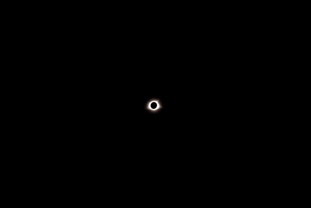 a black background with a small white dot in the center