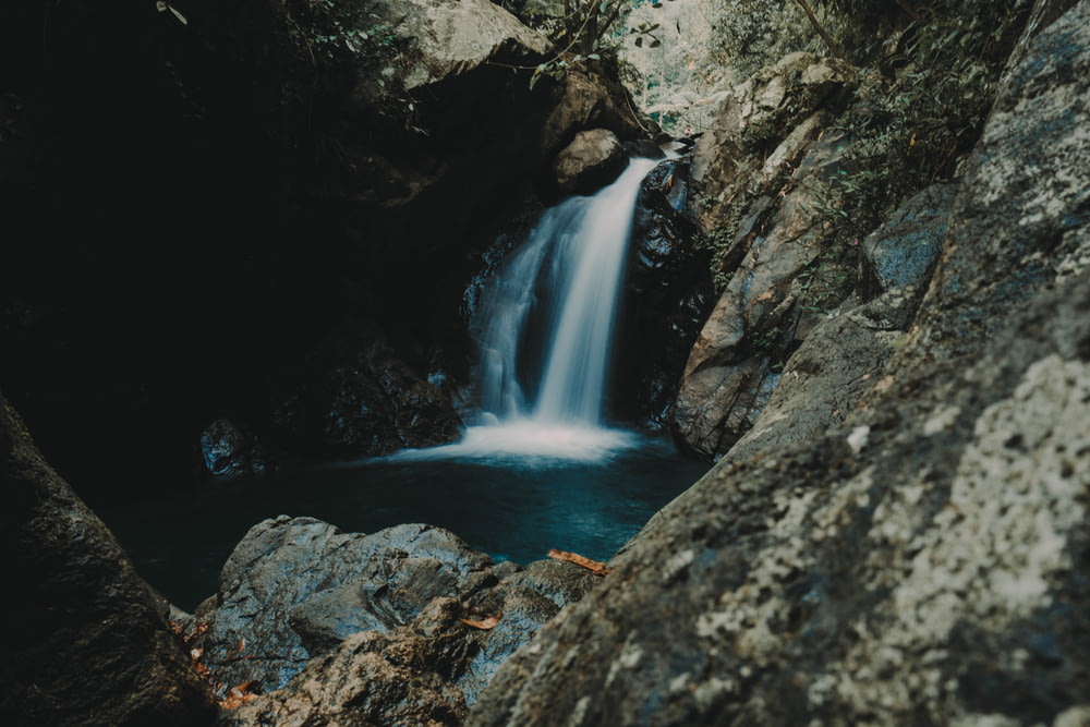 waterfalls near rock mountain