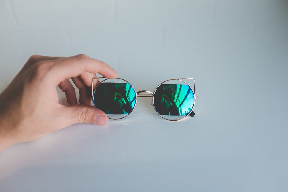 round silver-colored framed green lens sunglasses