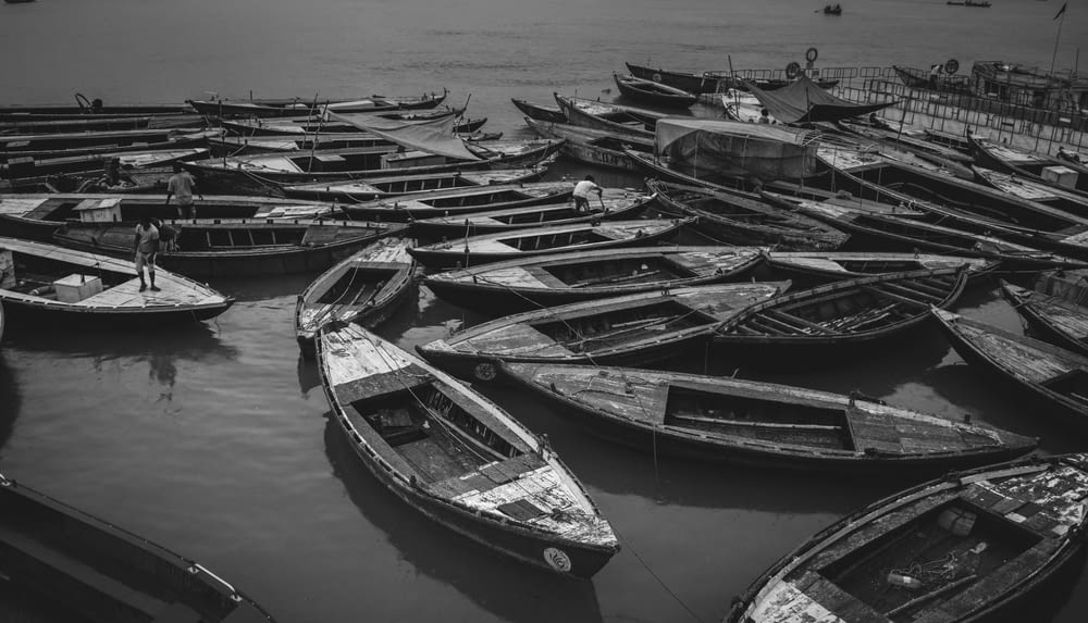 grayscale photo of boats on water