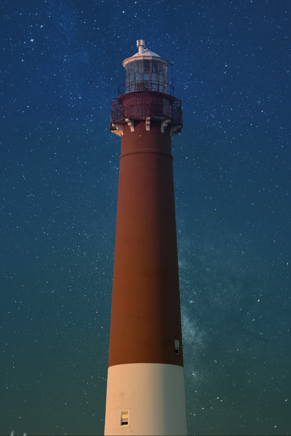 brown and white lighthouse during nighttime