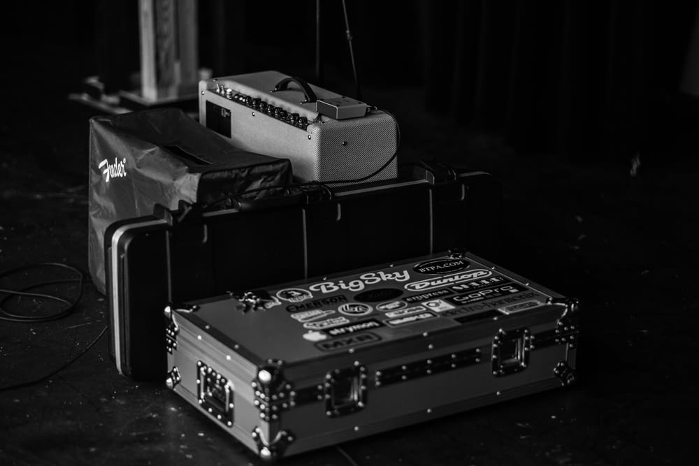 grayscale photography of suitcase